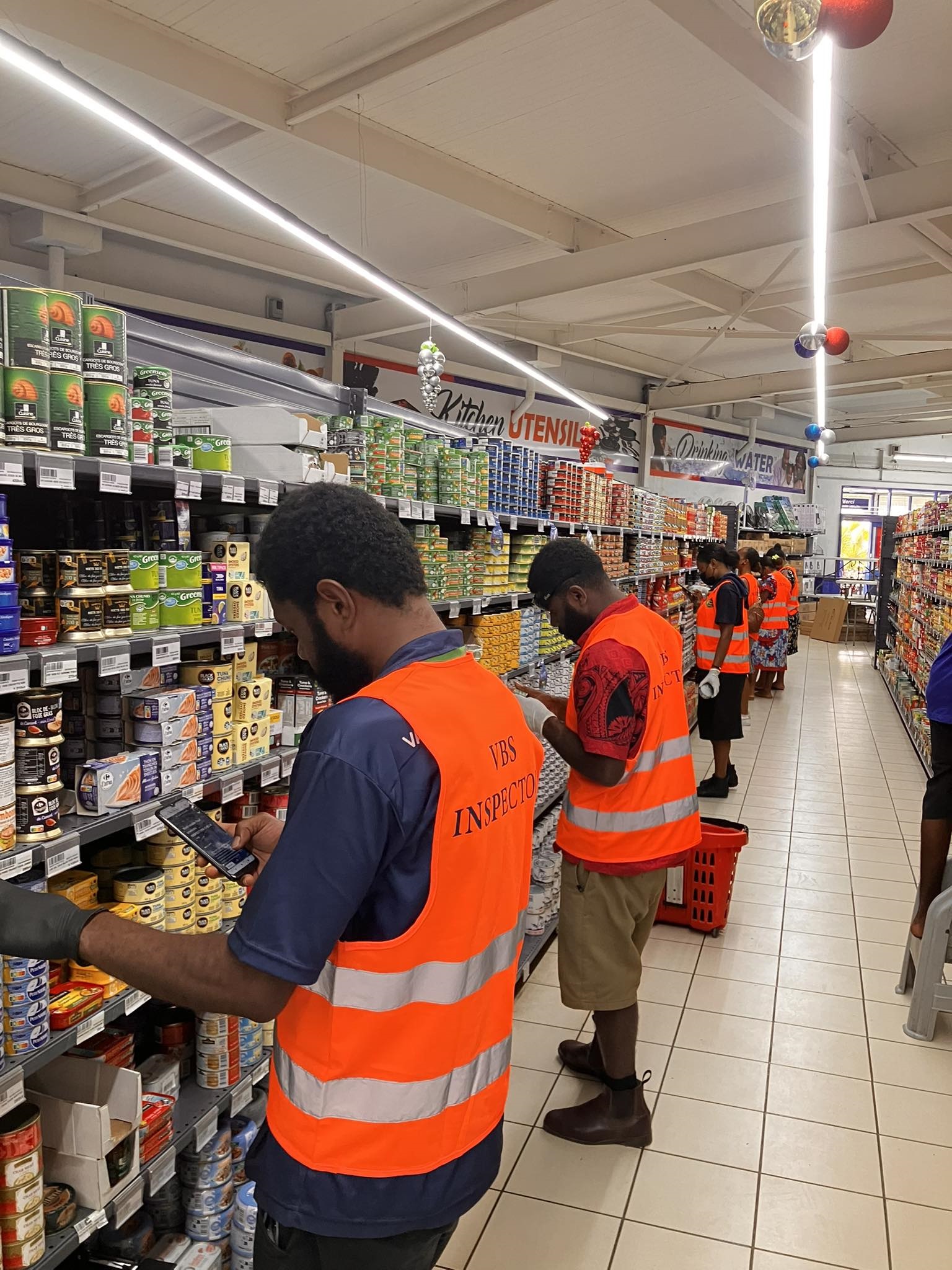 VBS inspectors examining products on a retail shelf